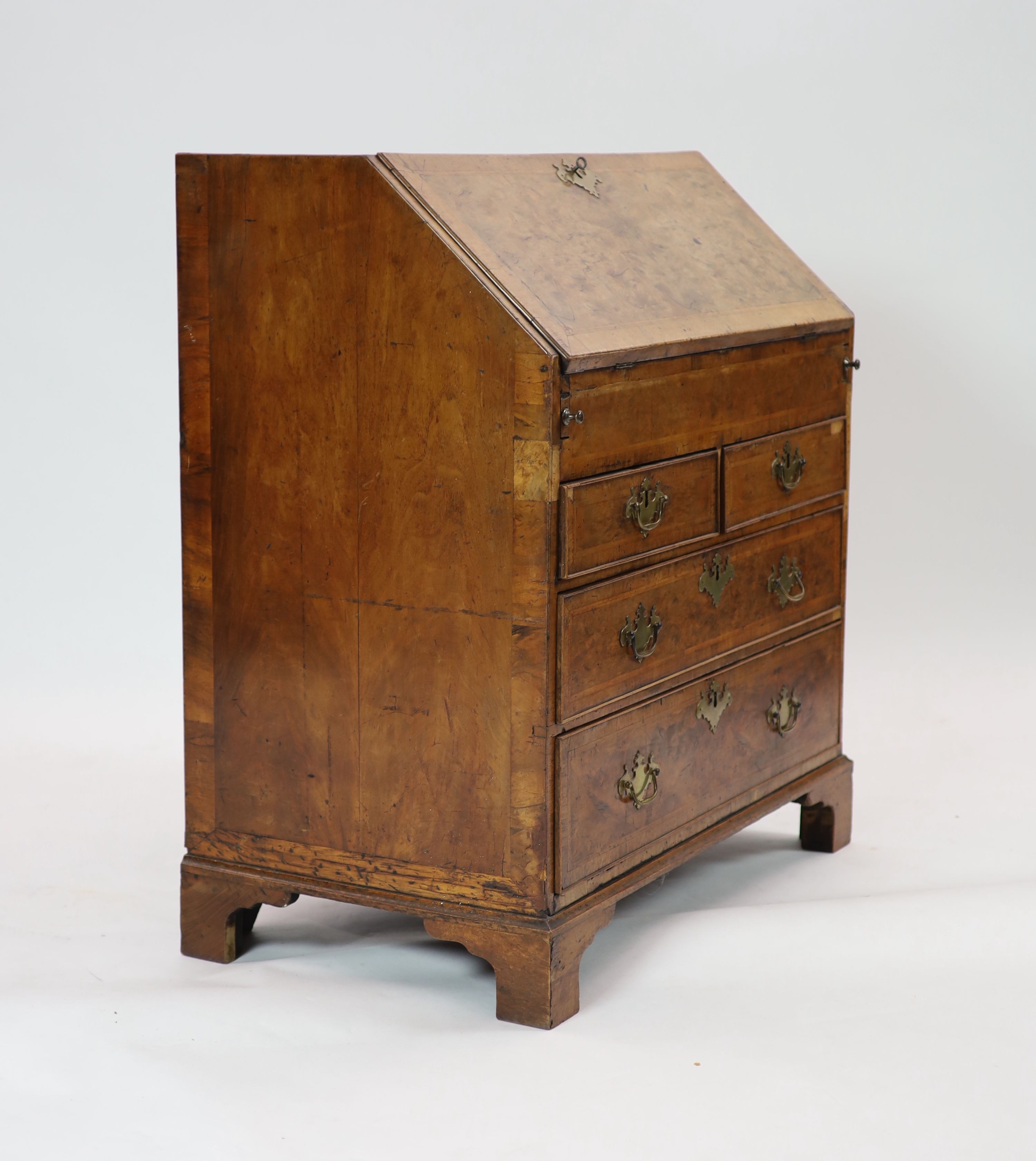 A George II walnut bureau H 101cm. W 92cm. D 53cm.